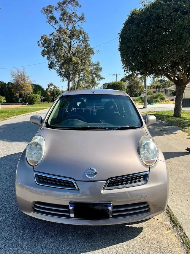 Silver Nissan Micra kerbside in a Perth street after a service